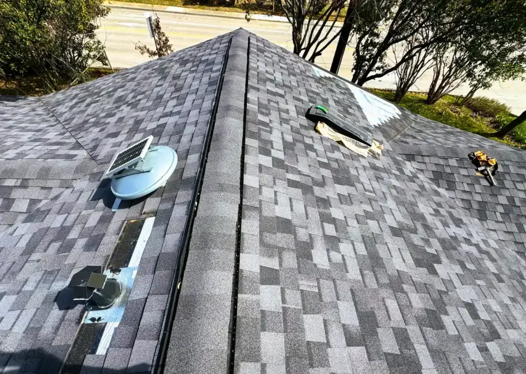 Finished shingle roof with a skylight, installed by Casas Pro