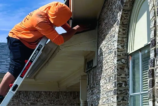 Casas Pro roofer on a ladder at a brick house